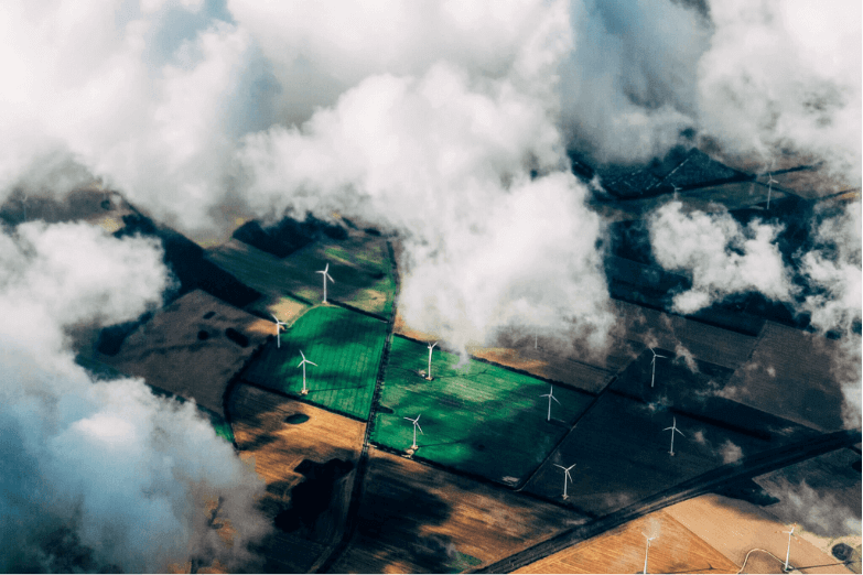 wind farms with clouds in fields