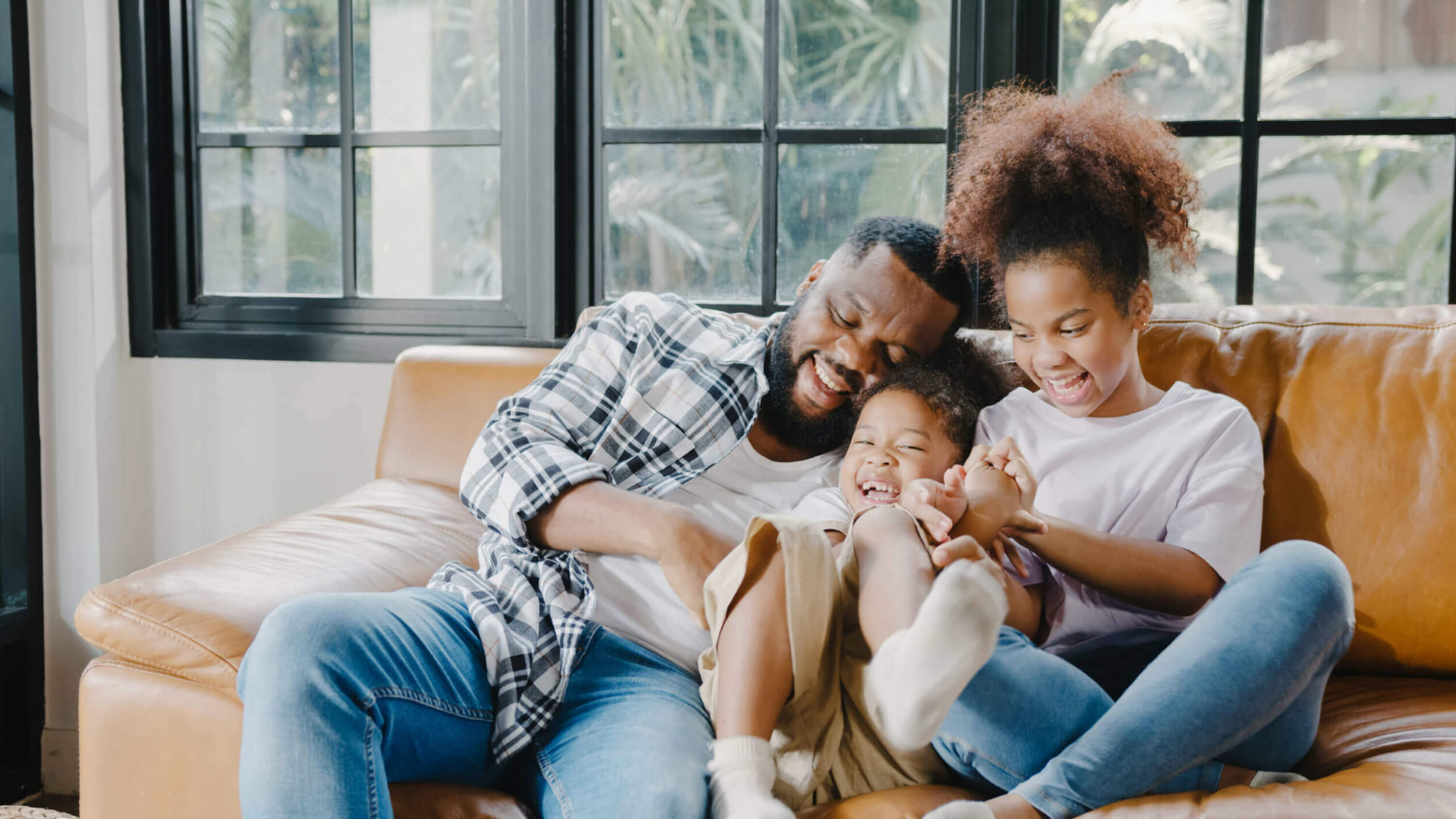 happy-cheerful-family-dad-daughter-having-fun-cuddle-play-sofa-while-birthday-house